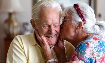 
		Pensioner kisses husband on cheek
	